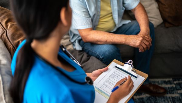 nurse taking notes about a male patient