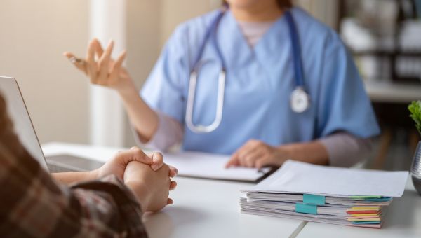 closeup of hands while doctor and patient are talking
