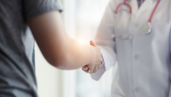 Woman shaking hands with their doctor after a visit about Alzheimer's.