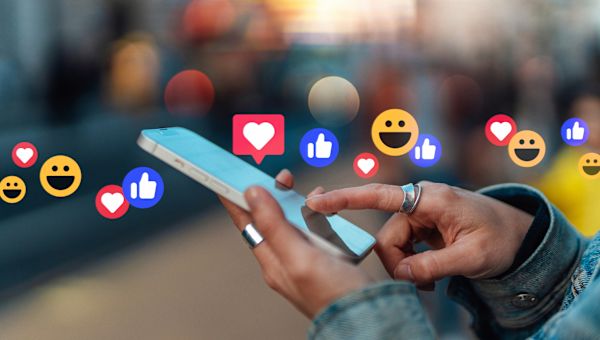 emojis emanate from a smartphone screen