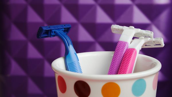 brightly colored razors in polka-dot cup