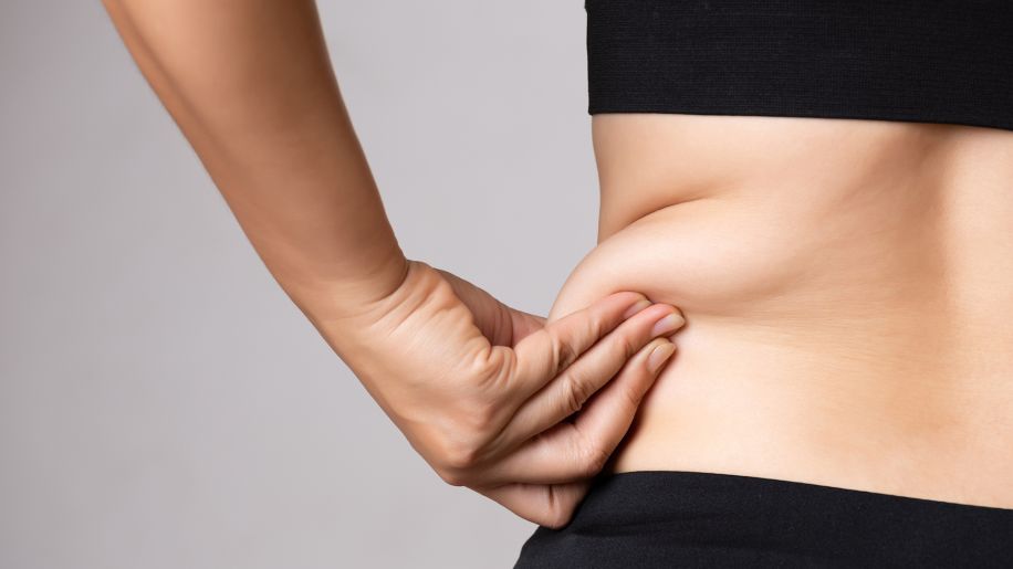 woman holding belly fat