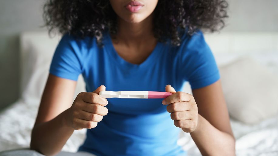 woman looking at pregnancy test