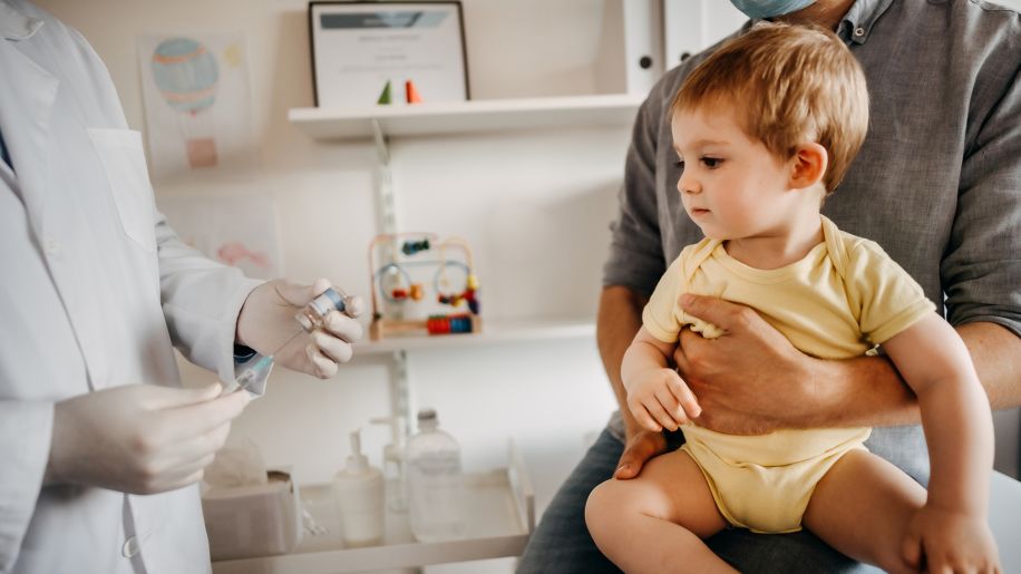 a boy at the doctor's office getting an Hib vaccine