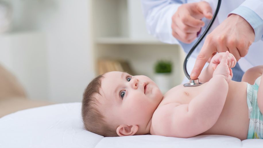 a baby getting checked out by a doctor