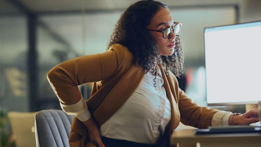 woman uncomfortable at desk