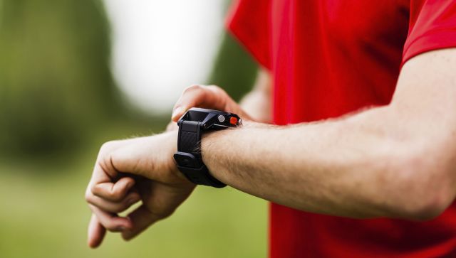 man checking health tracker on wrist