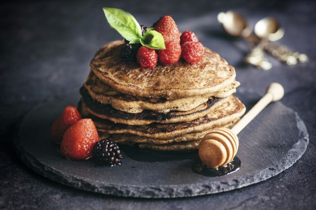 Buckwheat pancakes with berry fruit and honey.Selective focus