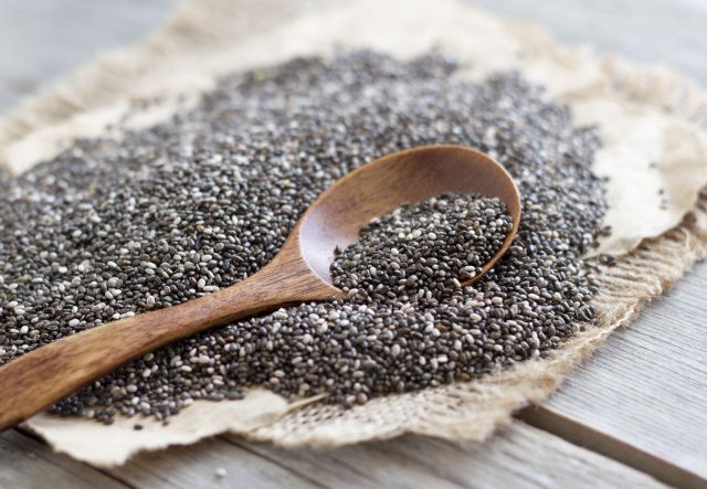A spoon rests in a pile of chia seeds rich in omega-3s—which are good for you.