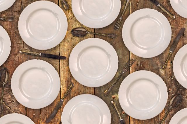 A table with empty plates is ready for the six-small-meals-a-day diet plan.  