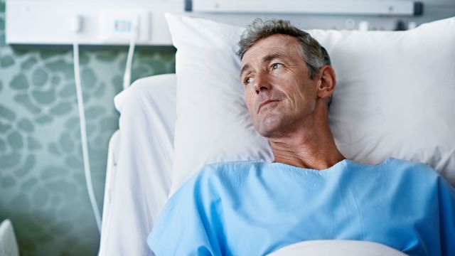 man in hospital bed