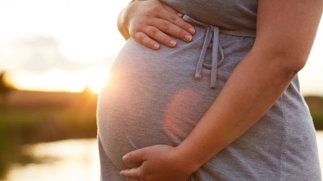 pregnant woman holding her stomach