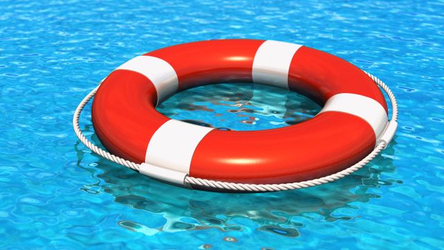 Lifesaver belt floating in swimming pool