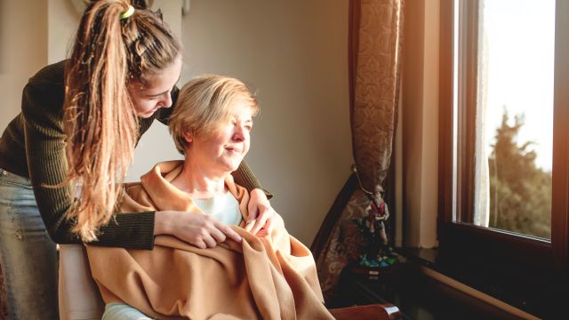 Young woman caring for elderly woman