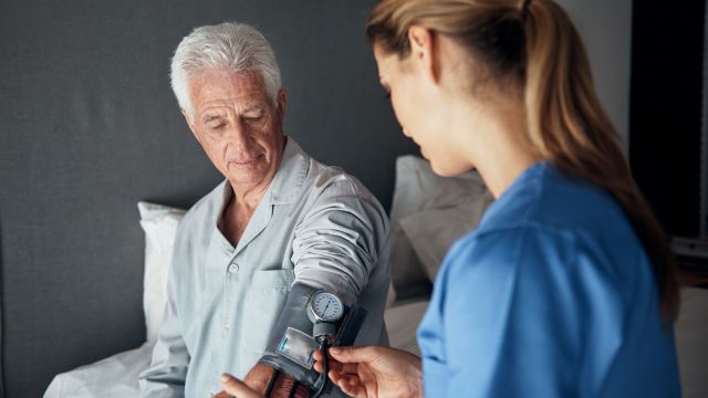 Nurse giving senior patient a health checkup