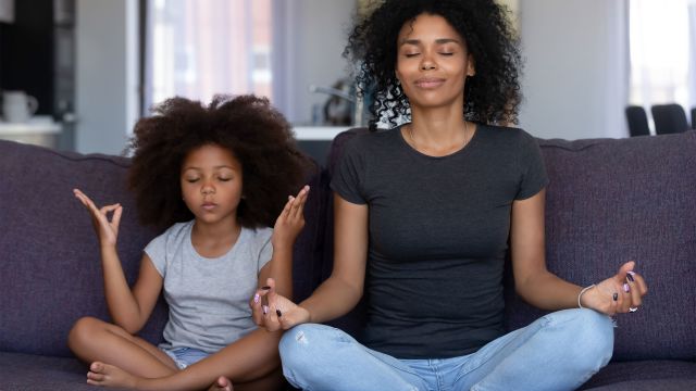Mother and daughter doing mindful meditation together