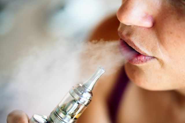 woman using an e-cigarette