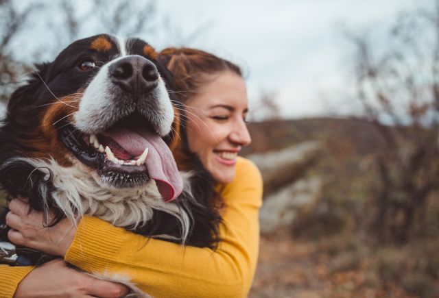 Young woman hugging awesome dog