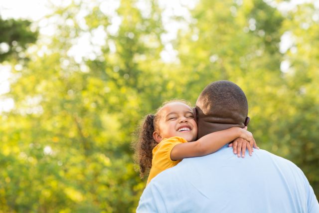 Someone holding/hugging their child