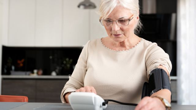 woman using blood pressure monitor