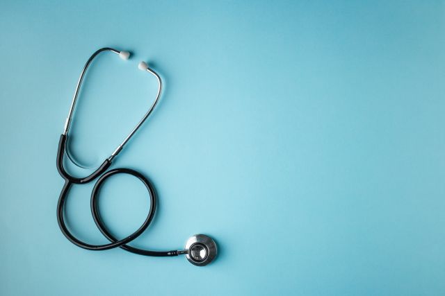 A stethoscope on a blue background.