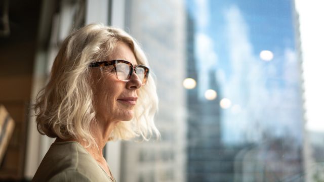 older woman looking out a window