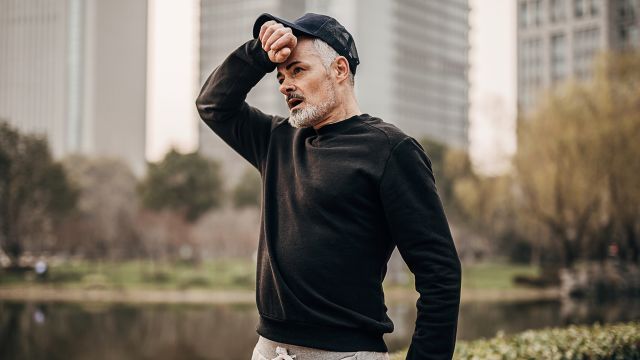 Older man tired during a run outside.