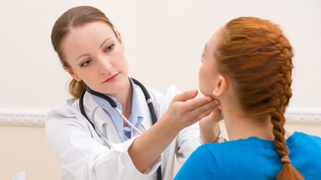 Endocrinologist testing female patient at office.