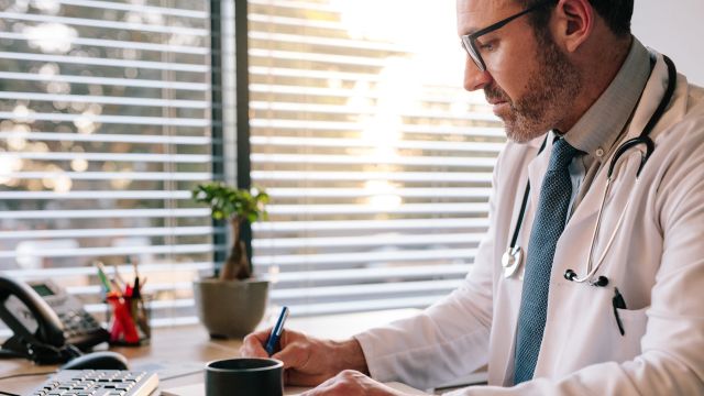 Physician working at their desk.