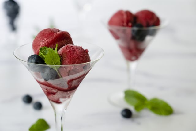 Scoops of raspberry sorbet with mint in martini glasses