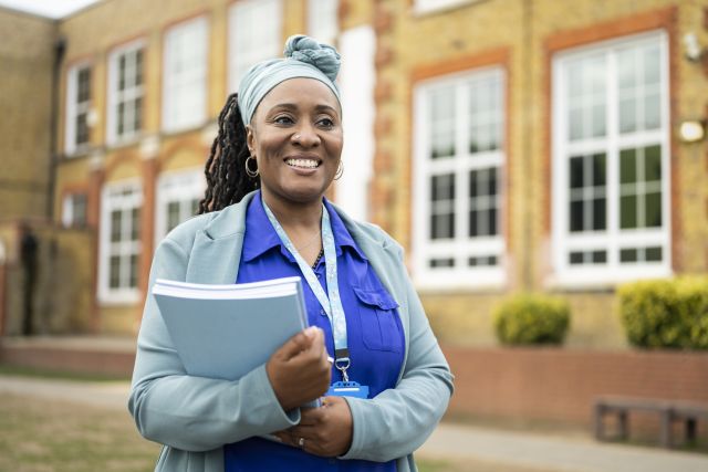 someone who is smiling and holding a book