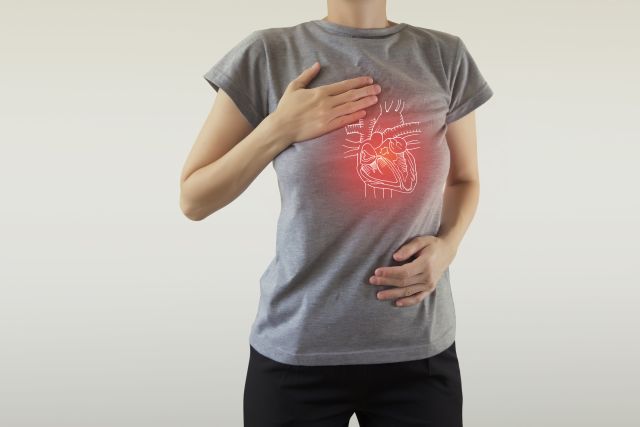 A young woman has a diagram of a heart superimposed over her chest.
