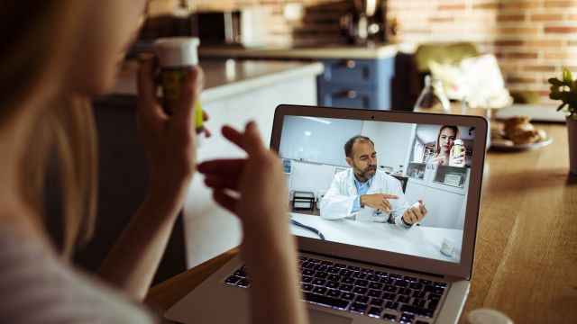 A woman with psoriasis has a telehealth appointment with her healthcare provider.