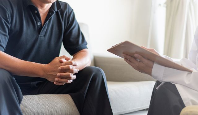 a white man consults with a healthcare provider about a medical condition