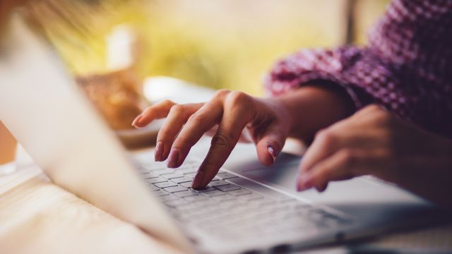 woman typing on laptop