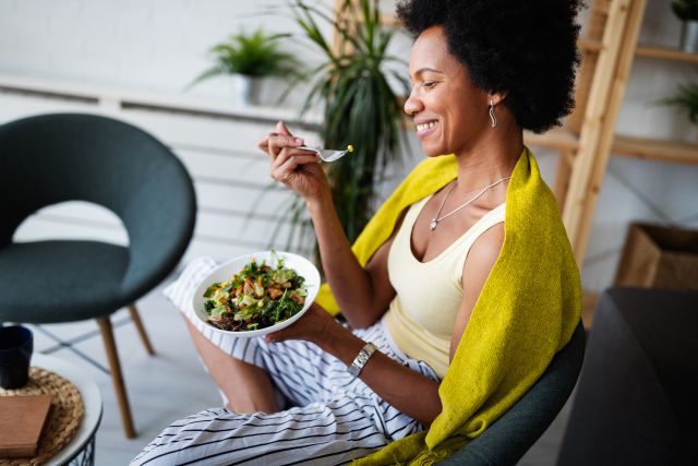 woman eating green salad