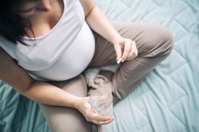 pregnant woman taking pill