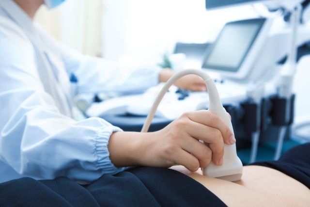 healthcare provider using an ultrasound to monitor for ovarian cysts