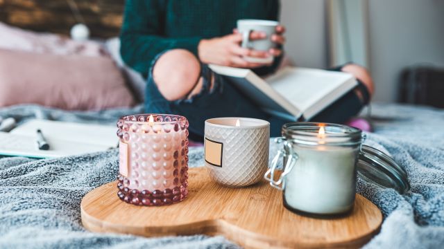 A young mom relaxes with a cup of tea and a book. Self-care is important for parents who care for a child with a medical condition like NF1.
