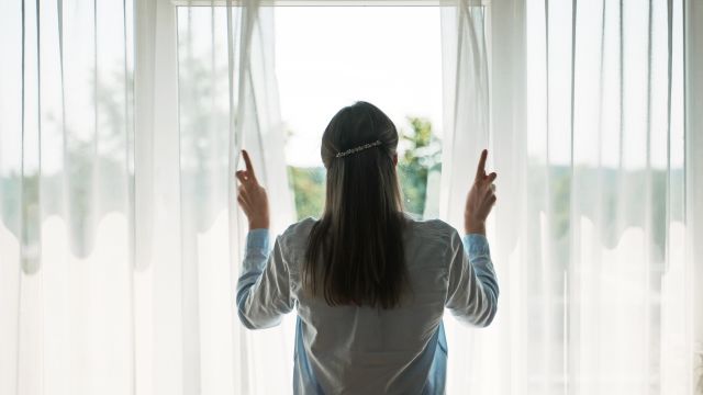 Woman with allergies closing her window