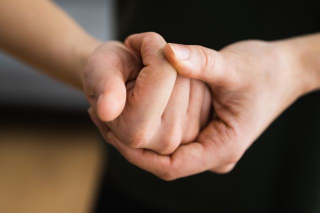 closeup of a man's hands popping knuckles