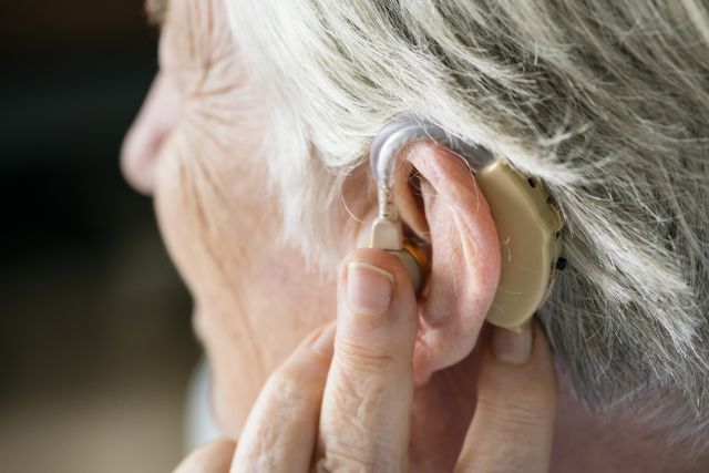 close up of older adult wearing hearing aids