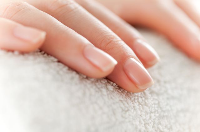 closeup of a woman's fingertips with a nice manicure