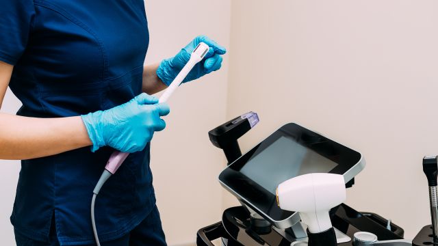 Doctor prepares energy-based vaginal rejuvenation device