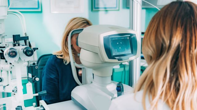 An eye doctor performs a retinal exam. Diabetic macular edema is a diabetes complication that affects the macula, the central part of the retina in the eye.