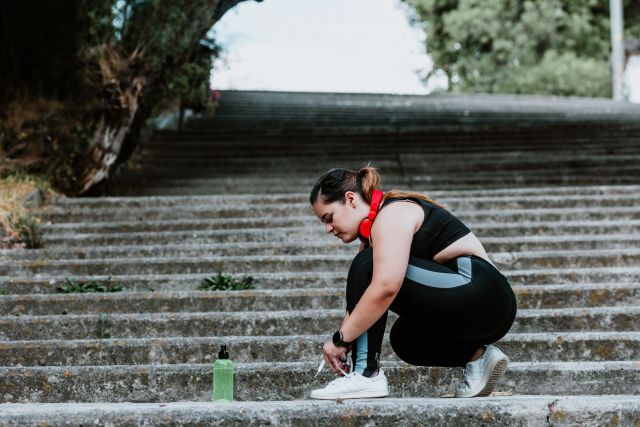 someone lacing their shoes and getting ready to exercise