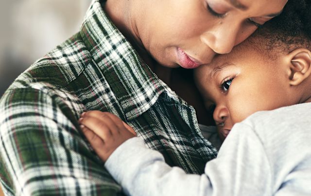 parent holding and comforting baby