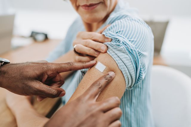 mature woman receiving shingles shot in arm