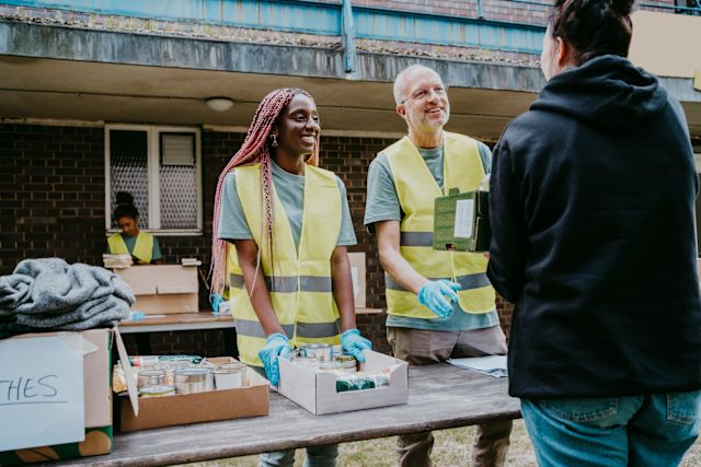 two volunteers helping a person in need