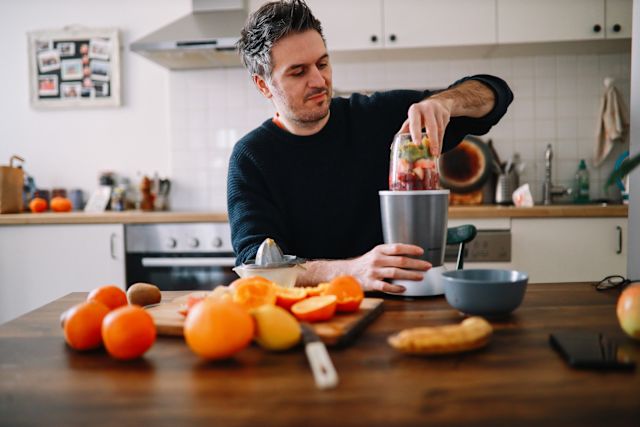 man making smoothie